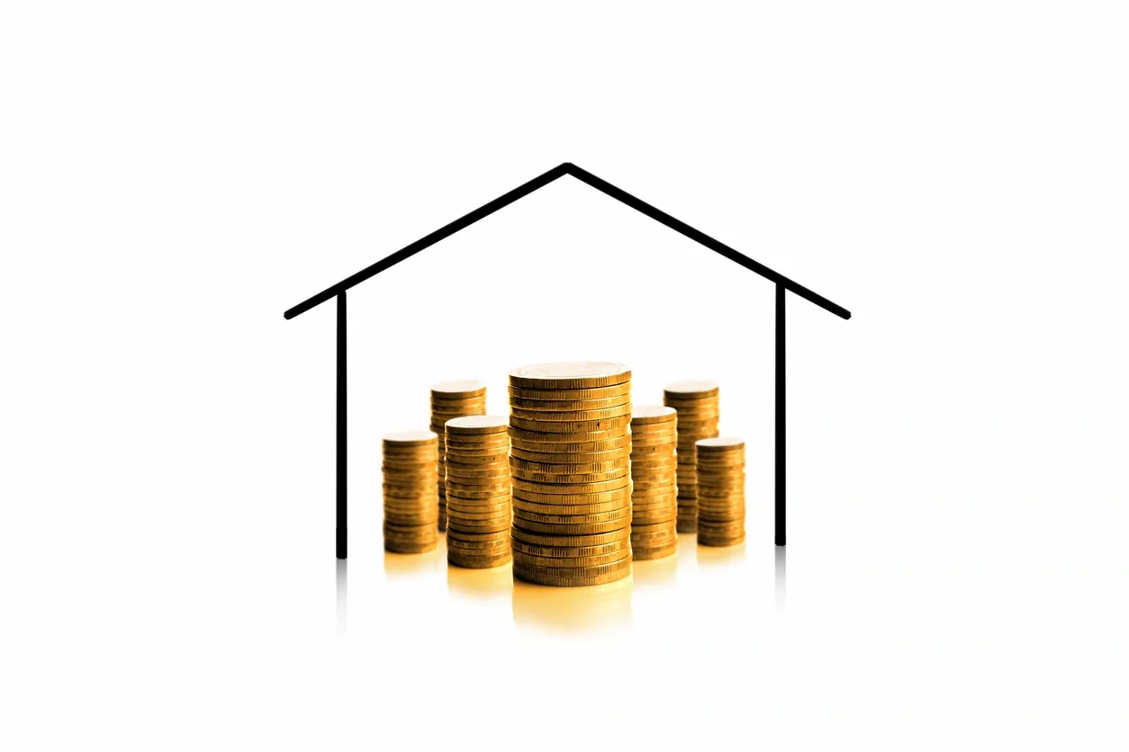 The image depicts a stack of coins in ascending order, symbolized as a house with a line drawing over them, implying a concept of real estate investment or savings.